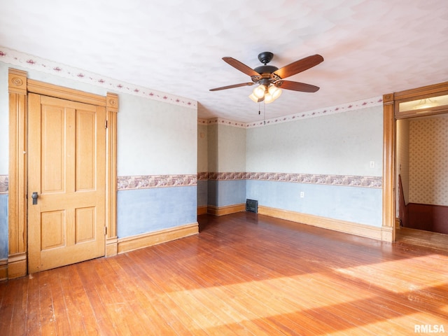 empty room featuring ceiling fan and wood-type flooring