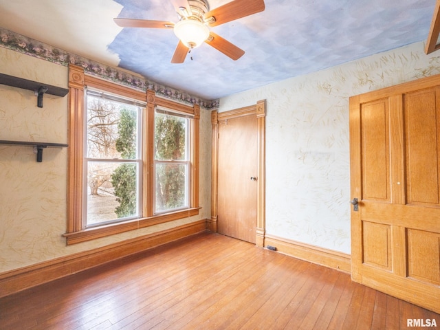 empty room featuring light hardwood / wood-style flooring and ceiling fan