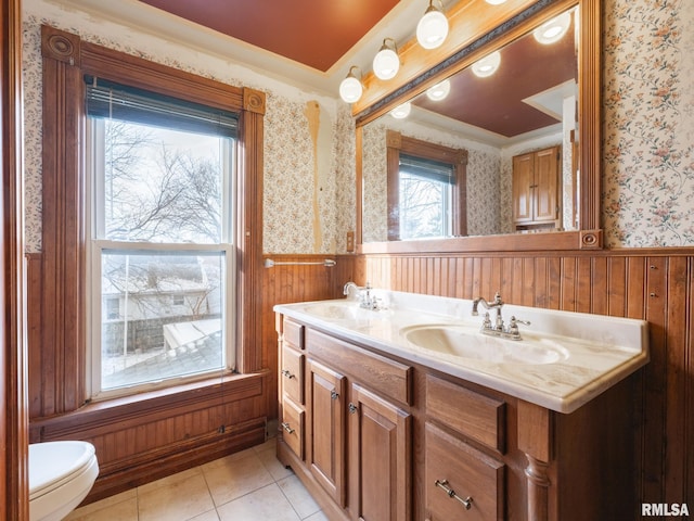 bathroom featuring wood walls, tile patterned flooring, vanity, and toilet