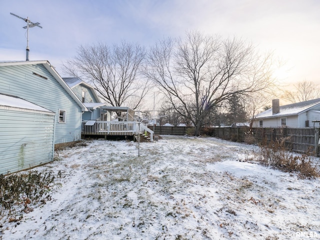 yard layered in snow featuring a wooden deck