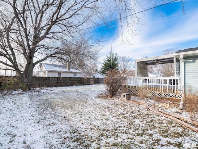 yard covered in snow featuring a wooden deck