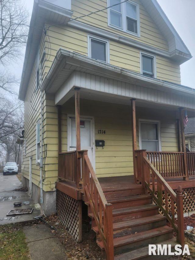 american foursquare style home featuring covered porch