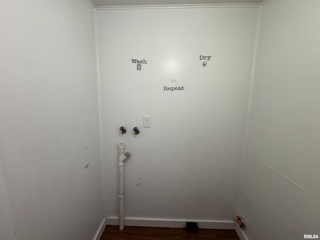 clothes washing area featuring dark hardwood / wood-style flooring, ornamental molding, and hookup for a washing machine