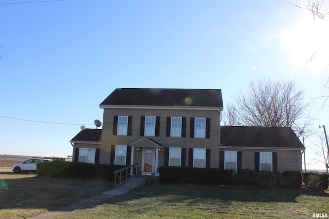 colonial-style house with a front yard