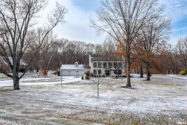 yard covered in snow featuring a garage