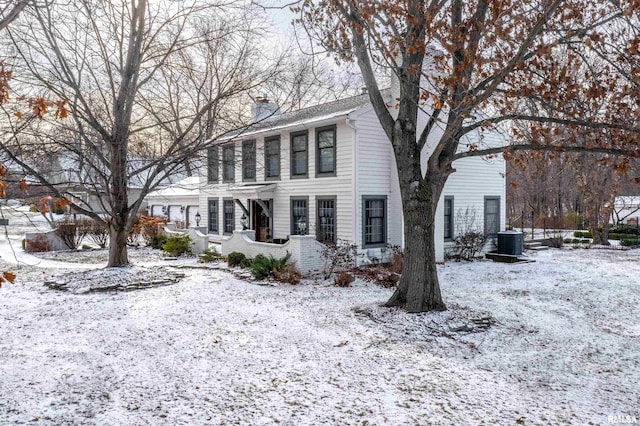 colonial-style house featuring central AC unit