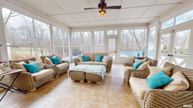 sunroom with ceiling fan, a paneled ceiling, and a wealth of natural light