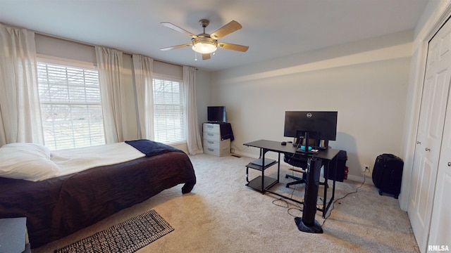 carpeted bedroom featuring ceiling fan and a closet