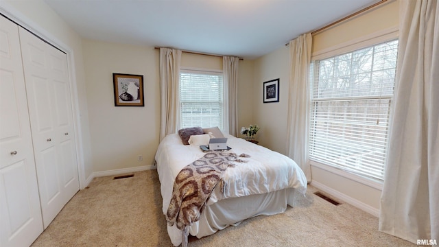 carpeted bedroom with a closet