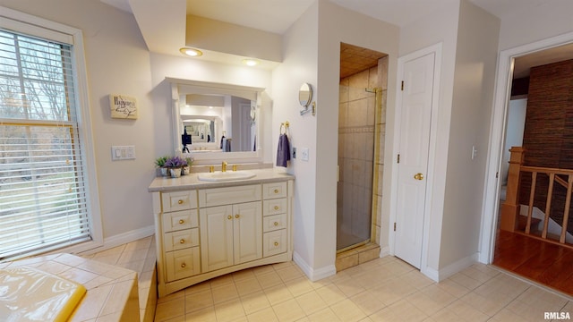 bathroom featuring tile patterned flooring, vanity, and a healthy amount of sunlight