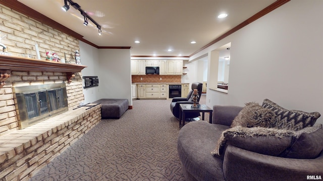 carpeted living room with crown molding, track lighting, and a fireplace