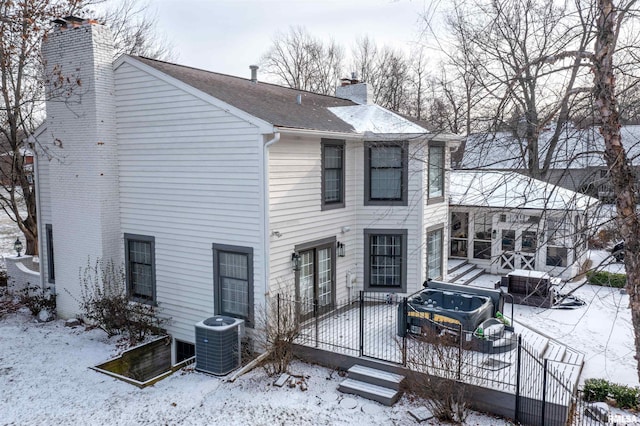 snow covered property with cooling unit