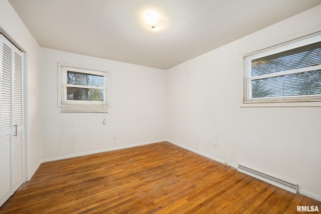 unfurnished bedroom featuring hardwood / wood-style floors and a closet