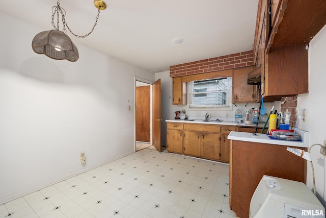 kitchen with sink, exhaust hood, and decorative light fixtures