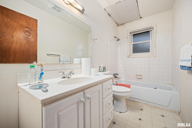 full bathroom featuring tile patterned floors, vanity, toilet, and tiled shower / bath combo