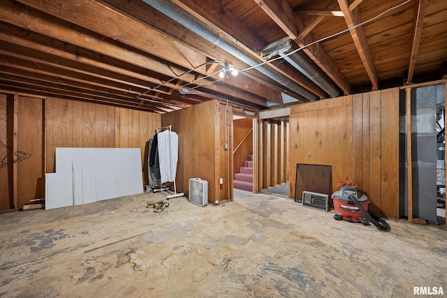 basement featuring wood walls