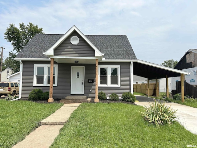 view of front facade featuring a front lawn and a carport