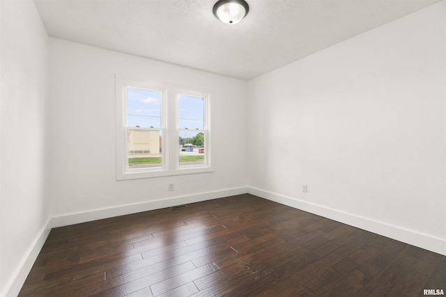 unfurnished room featuring dark hardwood / wood-style flooring