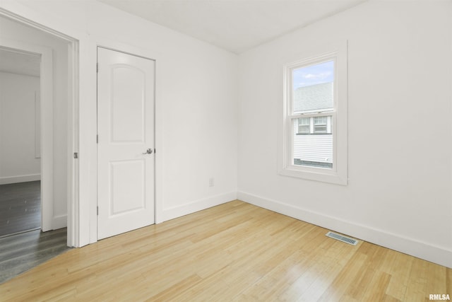 unfurnished room featuring hardwood / wood-style floors