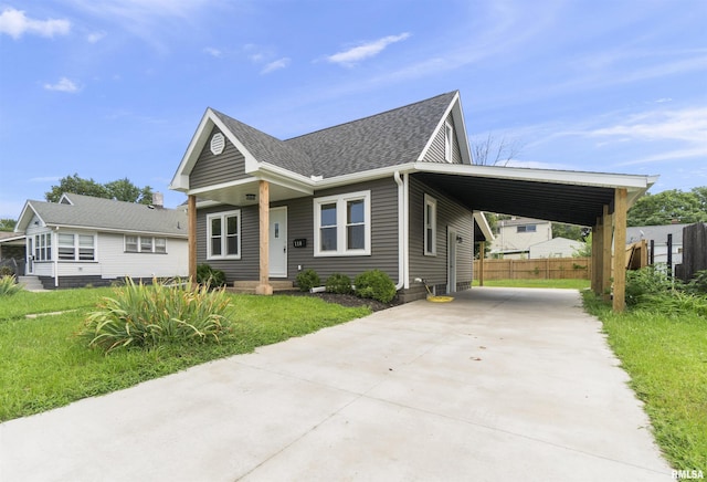 view of front facade featuring a carport and a front yard