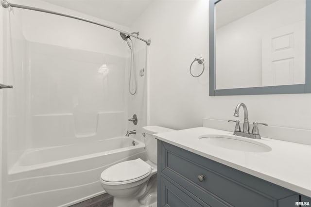 full bathroom featuring washtub / shower combination, wood-type flooring, vanity, and toilet