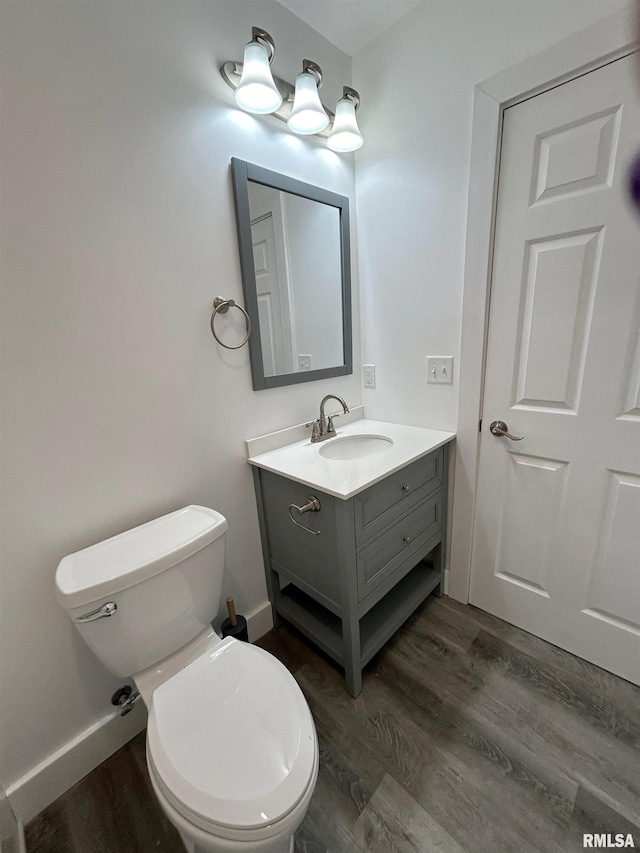 bathroom featuring hardwood / wood-style floors, vanity, and toilet