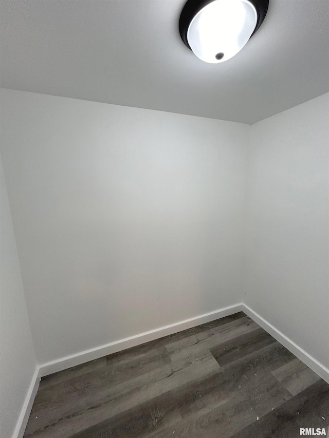 spare room featuring dark wood-type flooring