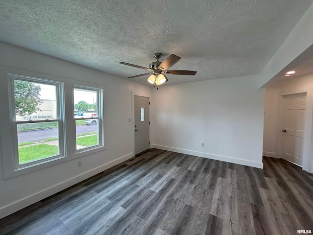 unfurnished room with a textured ceiling, ceiling fan, and dark wood-type flooring