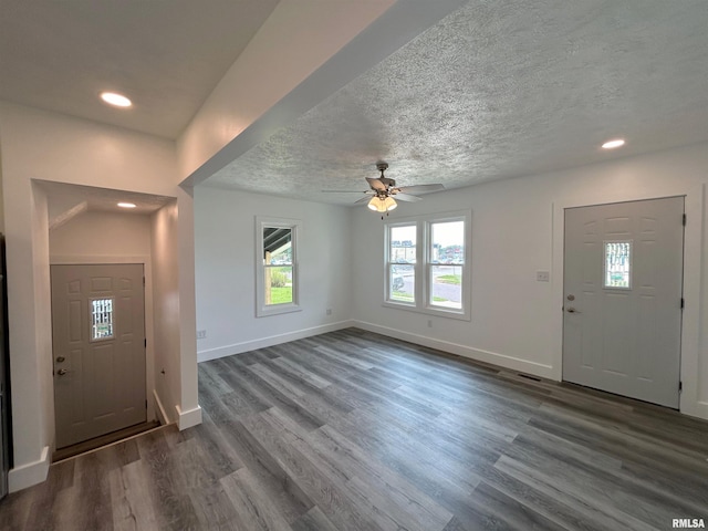 entryway with ceiling fan, dark hardwood / wood-style flooring, and a textured ceiling