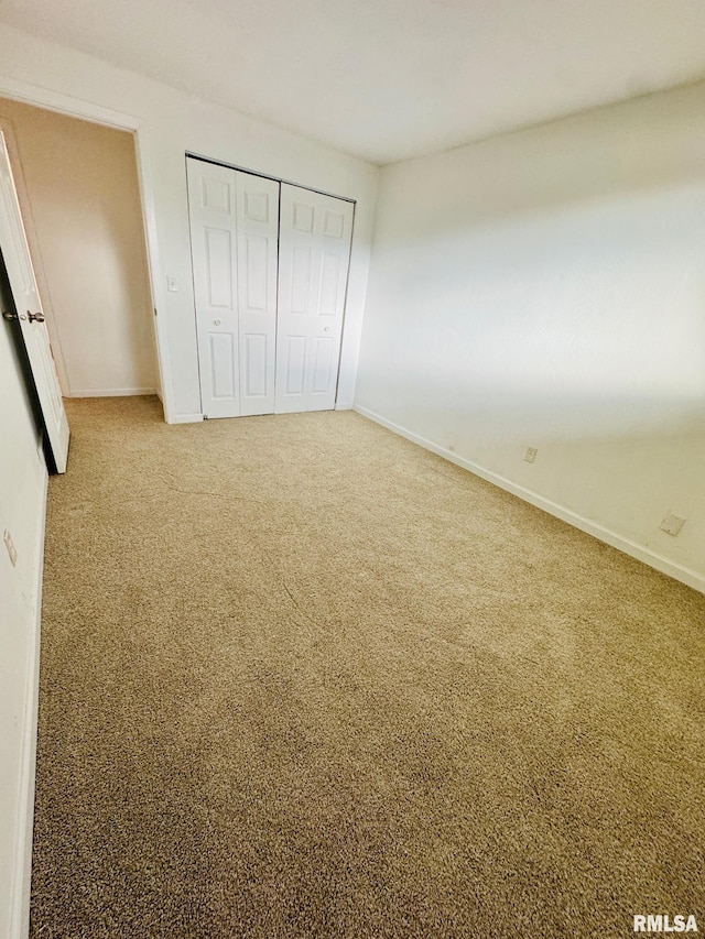 unfurnished bedroom with carpet floors and a closet