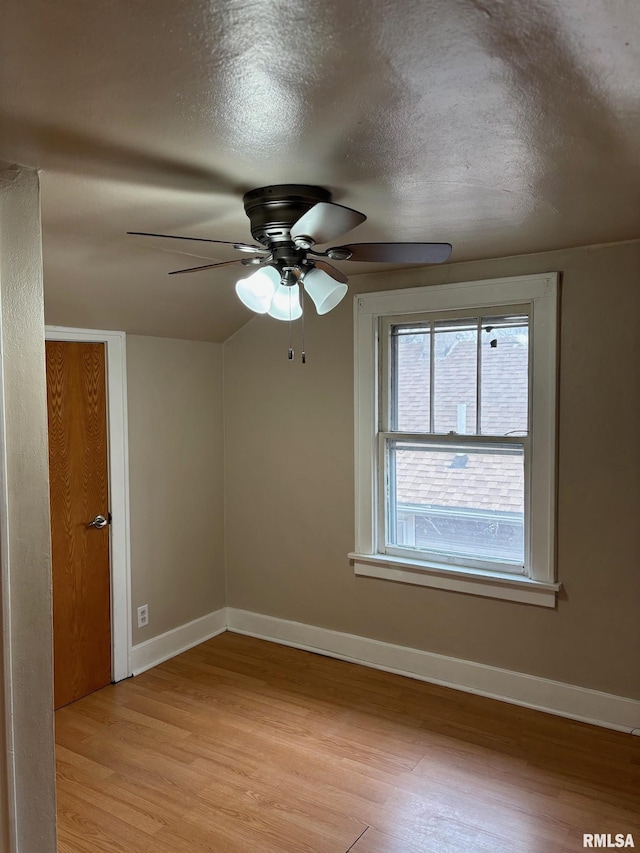 empty room with a textured ceiling, light hardwood / wood-style flooring, and ceiling fan