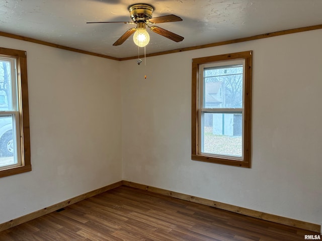 spare room with hardwood / wood-style flooring, ceiling fan, and crown molding