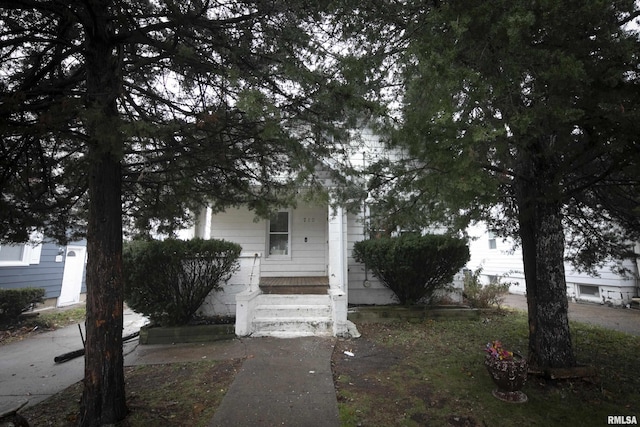 obstructed view of property with covered porch