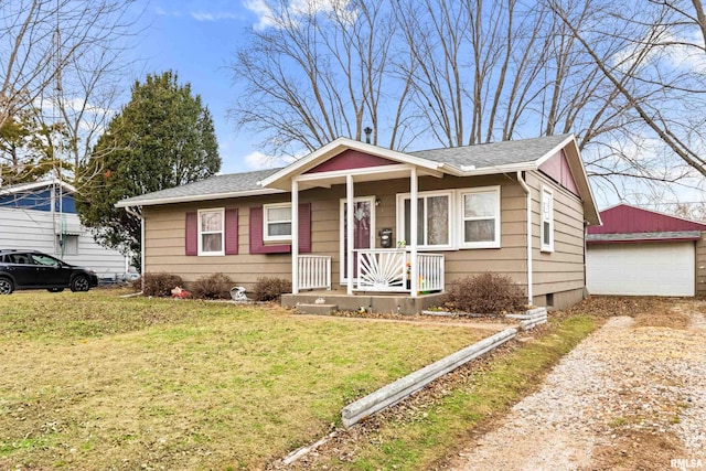 bungalow with an outbuilding, a front yard, and a garage