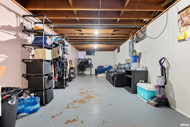 basement featuring wood walls