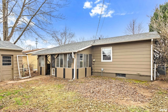 rear view of property with a sunroom