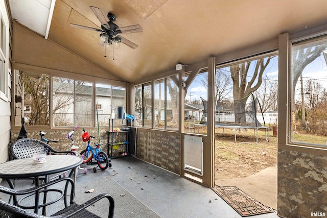 sunroom / solarium featuring a wealth of natural light, ceiling fan, and lofted ceiling