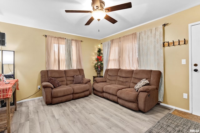 living room with ceiling fan and light hardwood / wood-style floors