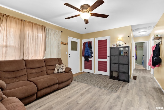 living room featuring ceiling fan and light wood-type flooring