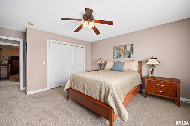 carpeted bedroom featuring a closet and ceiling fan