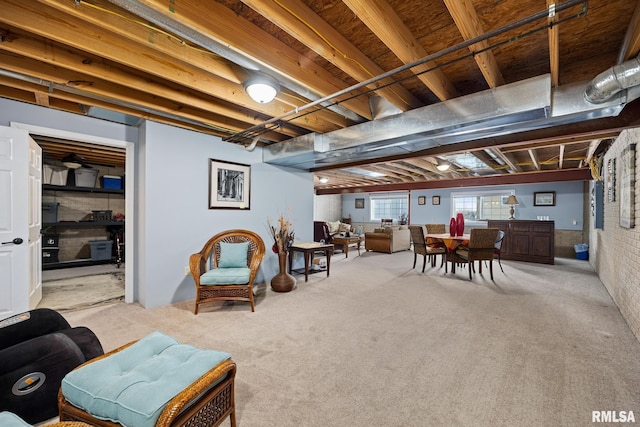 basement with light colored carpet and brick wall