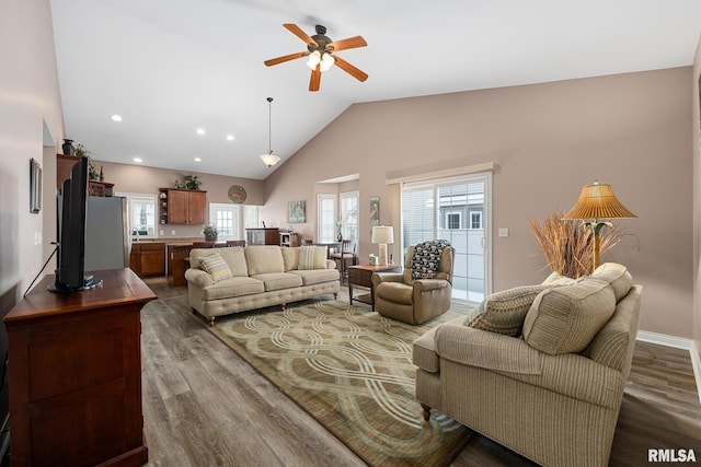 living room with dark hardwood / wood-style floors, high vaulted ceiling, and ceiling fan