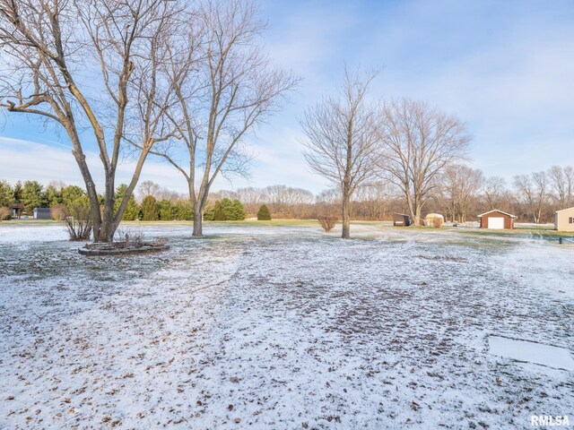 yard covered in snow featuring an outdoor structure