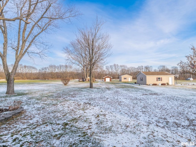 yard layered in snow featuring an outdoor structure