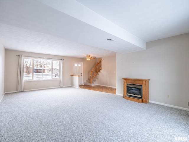 unfurnished living room featuring light carpet