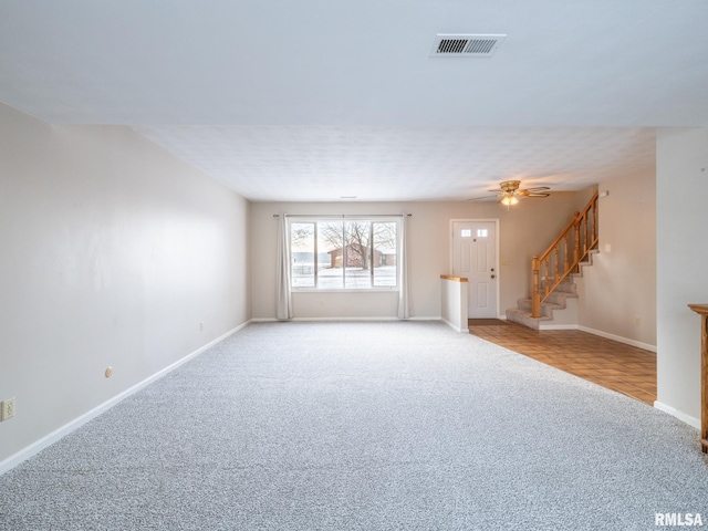 unfurnished living room with ceiling fan and light colored carpet