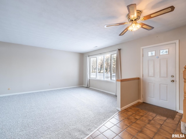 foyer entrance featuring ceiling fan and tile patterned flooring