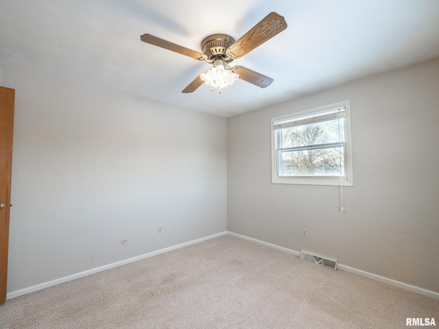 empty room featuring light carpet and ceiling fan