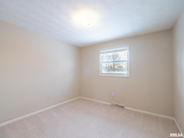 unfurnished room featuring light carpet