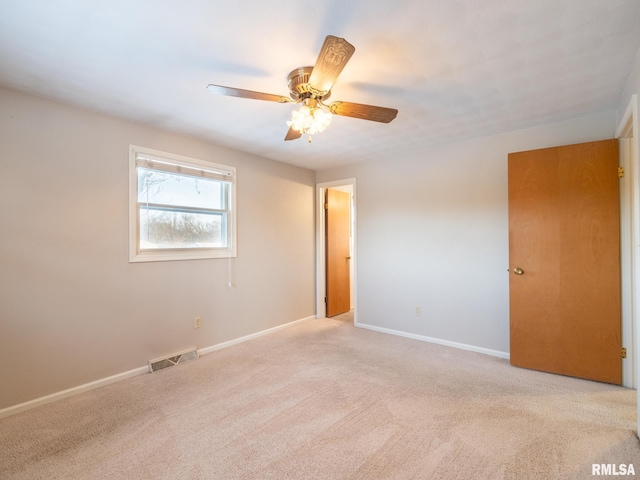 carpeted empty room with ceiling fan